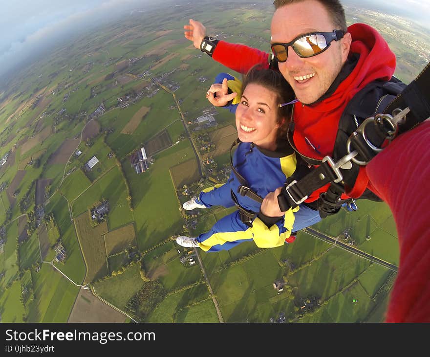 Woman and Man Wearing Overalls Sky Diving