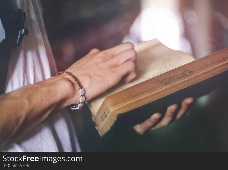 Person Holding Hardbound Book