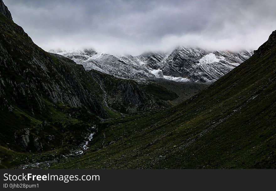 Mountain Valley Under Cloudy Sky