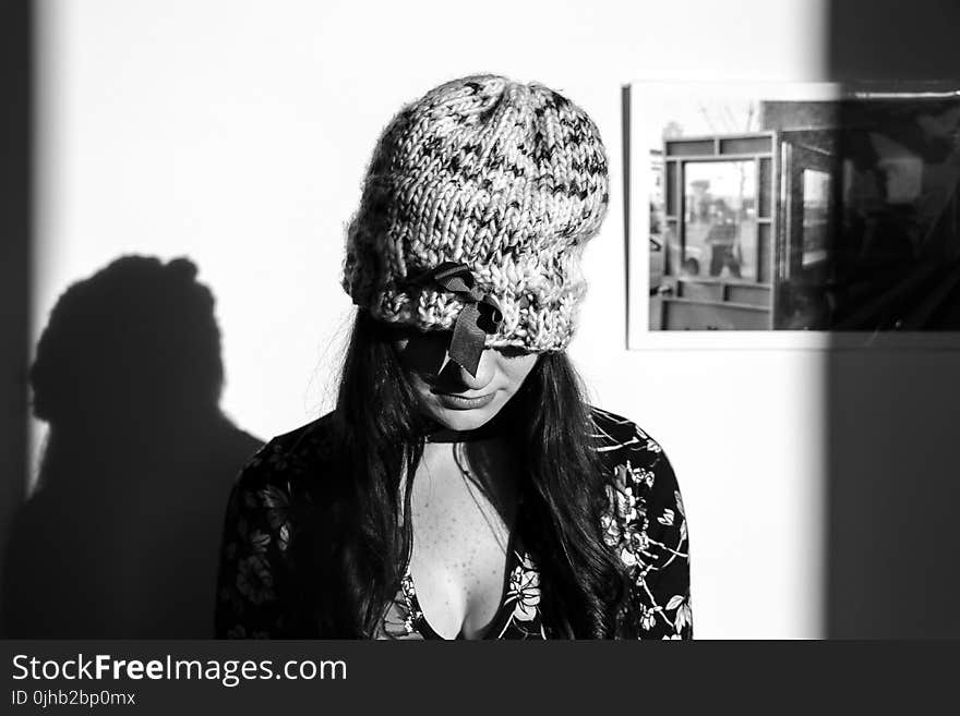 Greyscale Photo of Woman Wearing Knitted Hat and Floral Long-sleeved Top