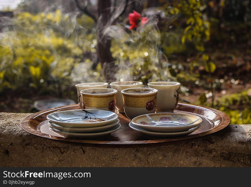 Brown Ceramic Teacups Beside Saucers on Brown Serving Plate