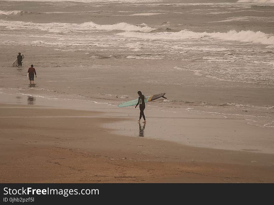 Person Holding of Green Surfing Board Near Lake