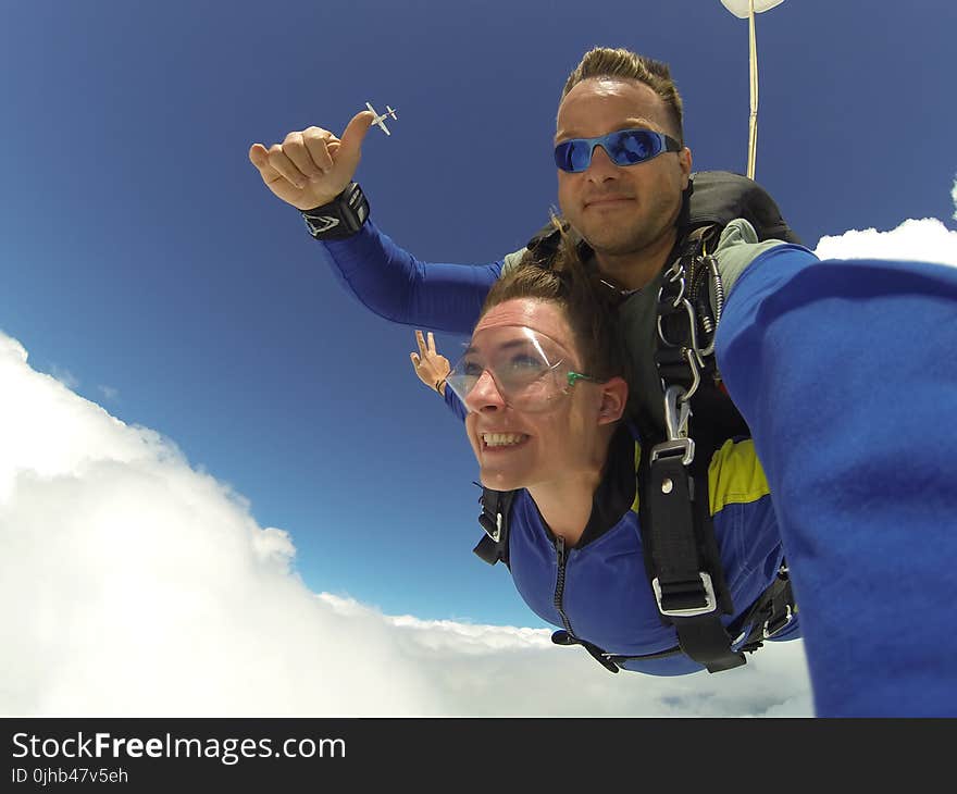 Man and Woman in Blue Jacket Doing Sky Diving