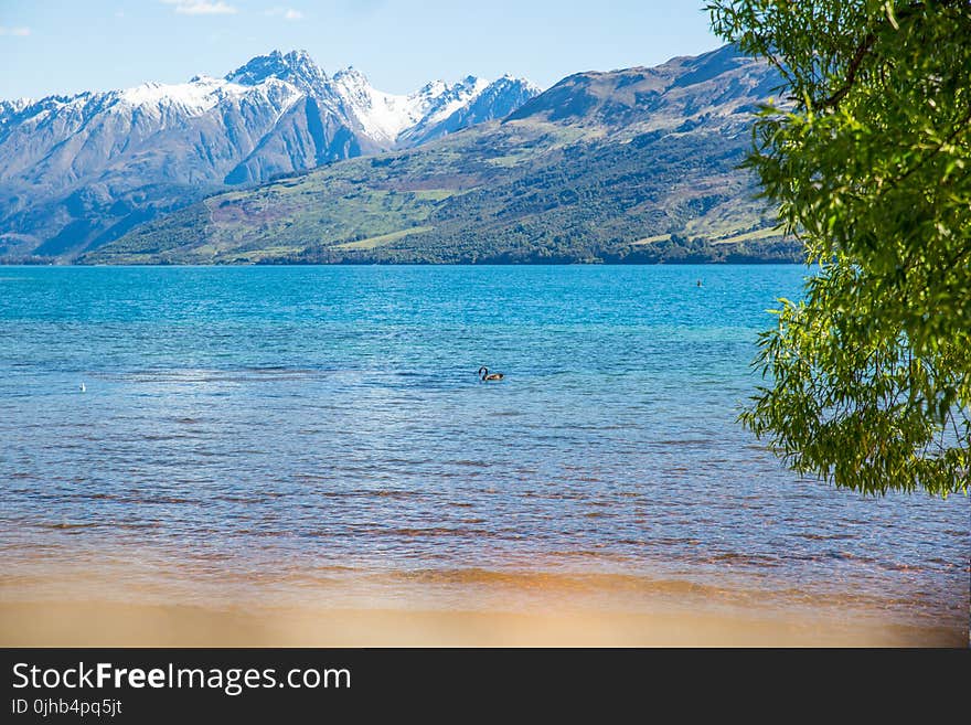 Landscape Photo of Body of Water With Mountain As Background