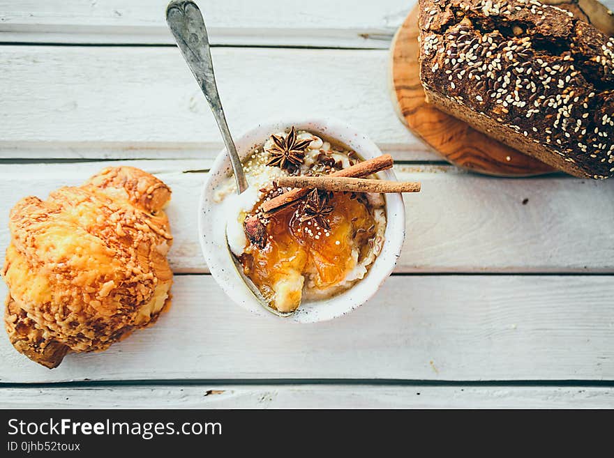 Three Assorted Dressed Foods on White Wooden Surface