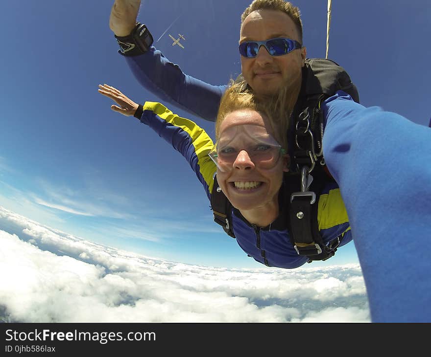 Fisheye Photography of Man and Woman Sky Diving