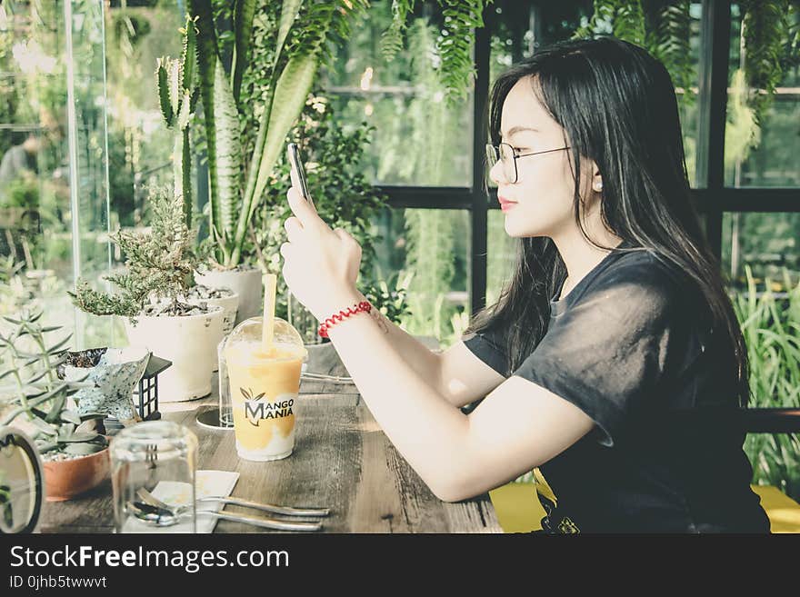 Photo of Woman Using Her Mobile Phone