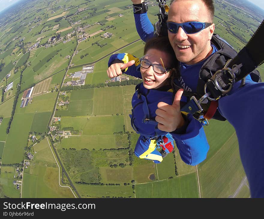 Couple in Blue Suit Paragliding