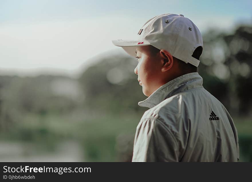 Boy Wearing Adidas Jacket and Gray Fitted Cap