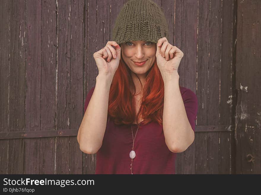 Woman Wearing Maroon Scoop-neck Shirt With Brown Knit Cap