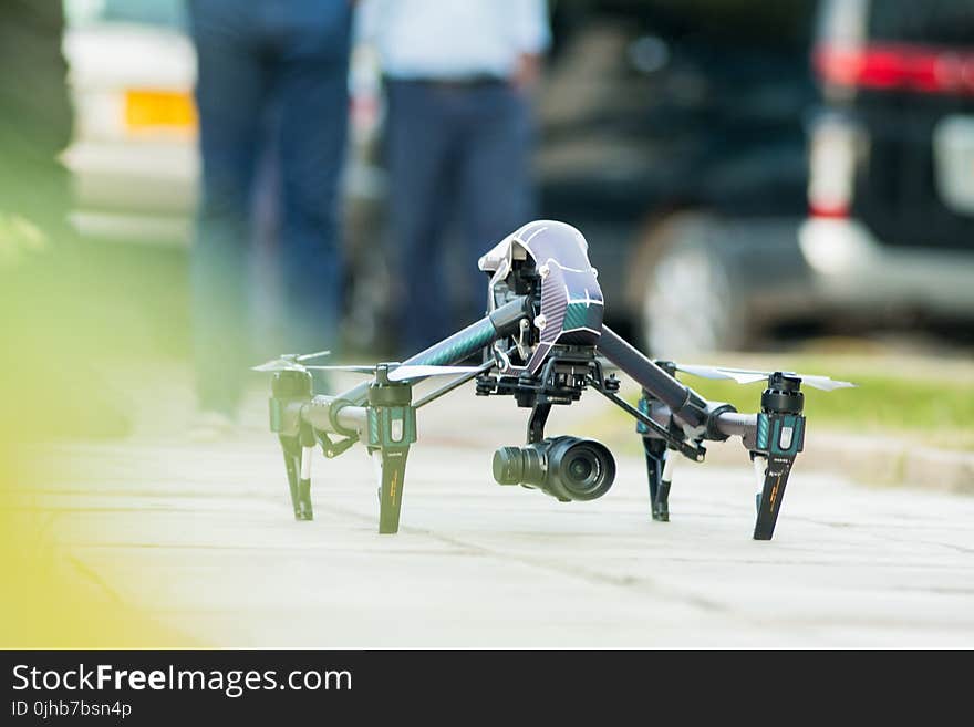 Gray and Green Quadcopter Drone on Ground