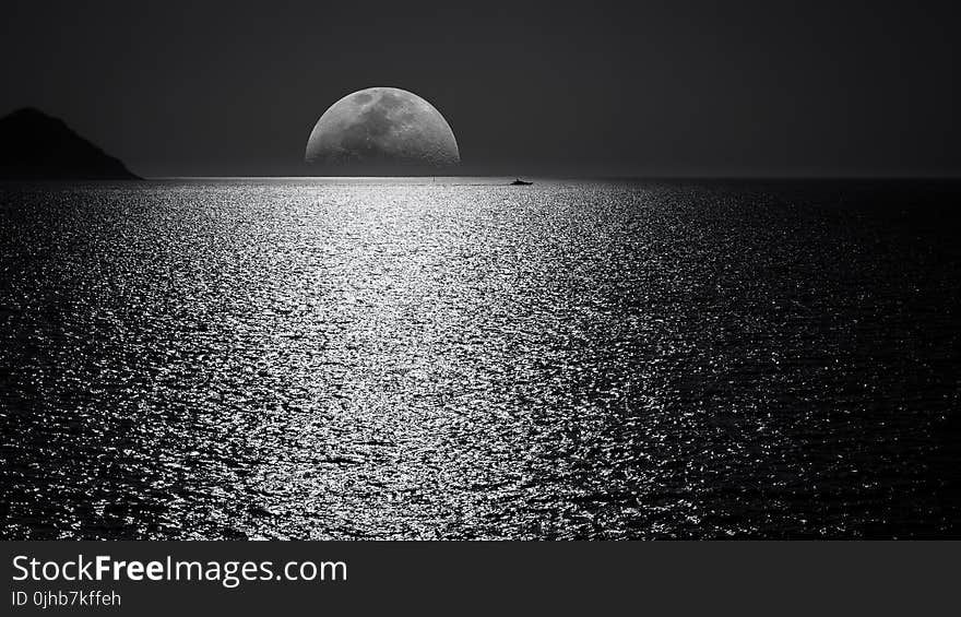 White and Black Moon With Black Skies and Body of Water Photography during Night Time