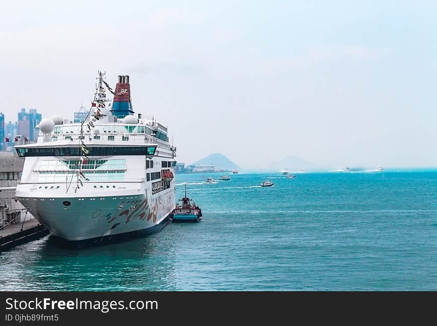 White Cruise Ship Docking in Port