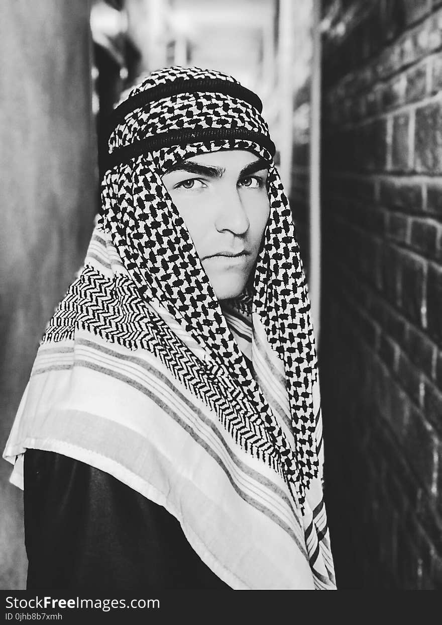 Grayscale Photo of a Man Wearing Keffiyeh