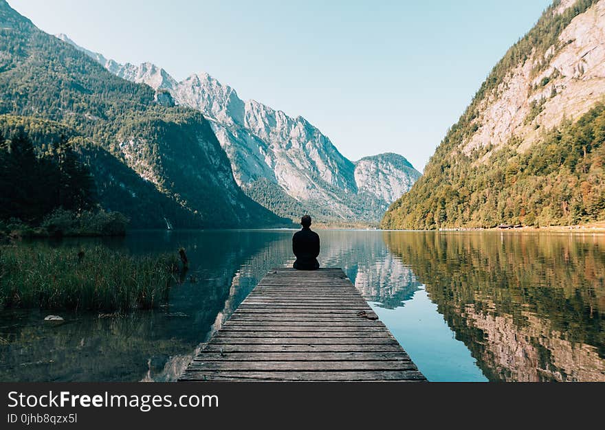 Person on a Bridge Near a Lake