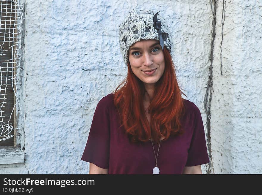 Photo of Woman in Maroon Top and Knitcap