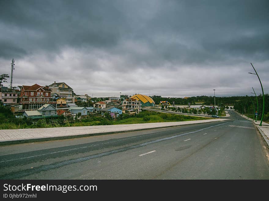 Village Beside Road Under Cloudy Sky