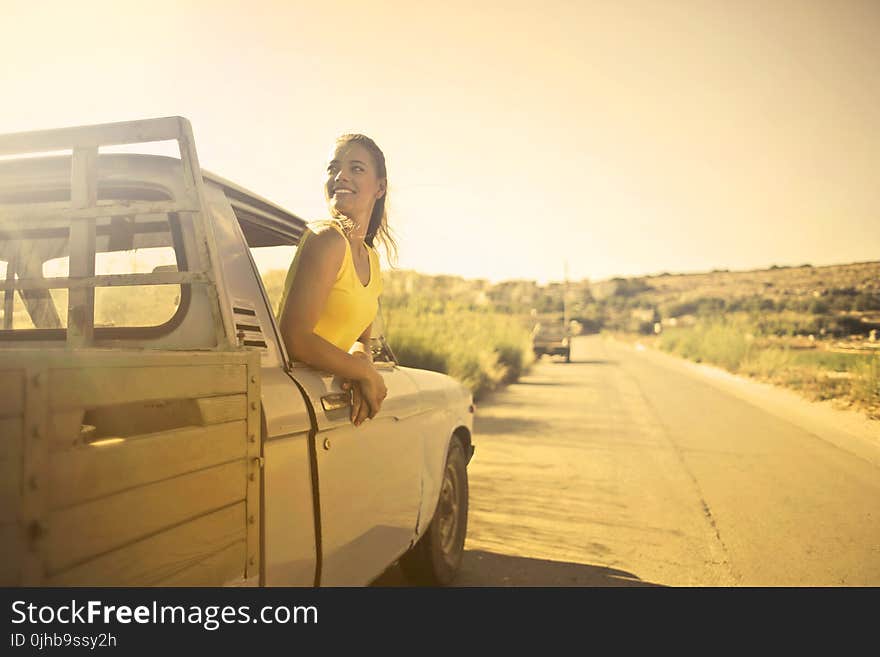 Woman Wearing Yellow Shirt Inside Pickup Truck