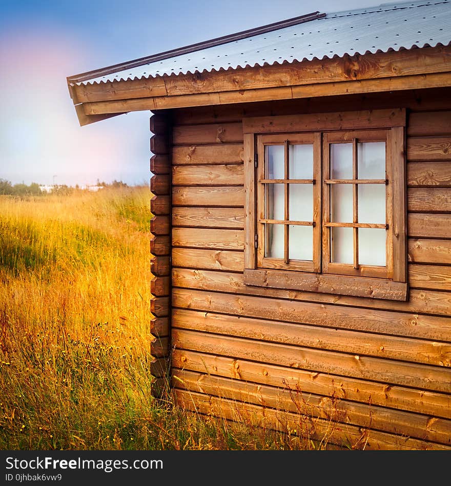 Brown Wooden Cottage at the Field during Day