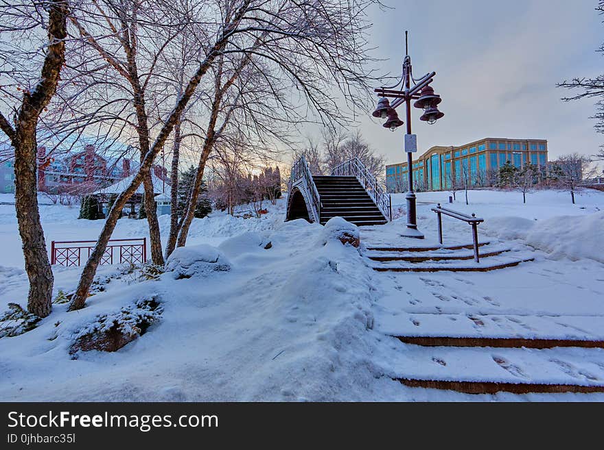 Bridge Near Light Post With Snow and Building at Distance