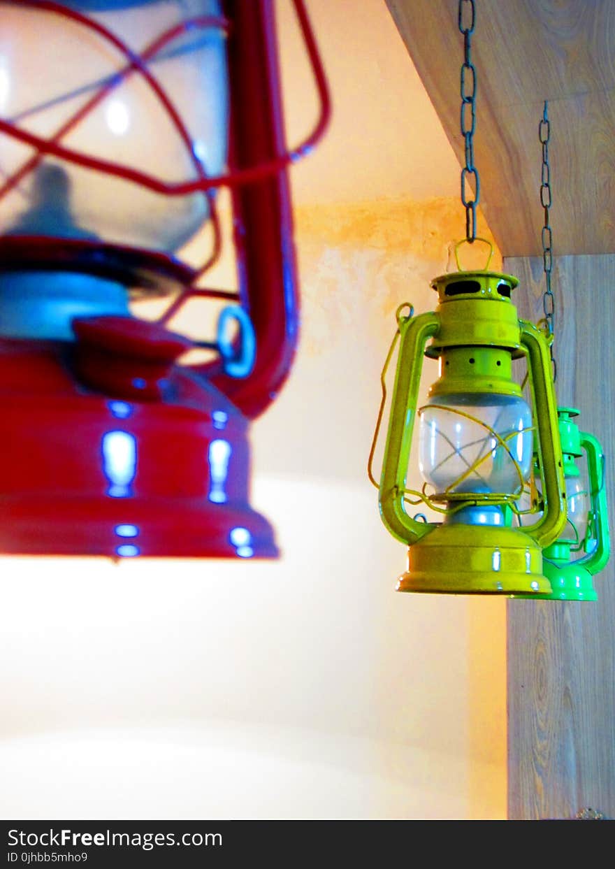 Three Red, Yellow, and Green Gas Lantern Hanging on Ceiling