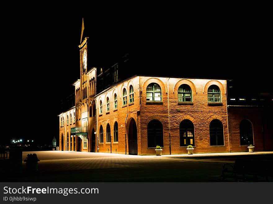 Brown Brick Building With Lights during Night Time