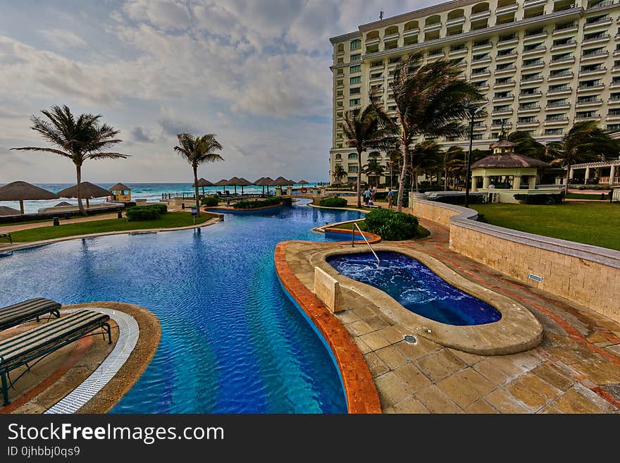 In-ground Pool Near Building during Daytime