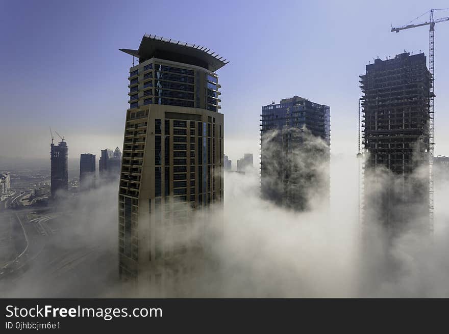 Three Brown High Rise Buildings