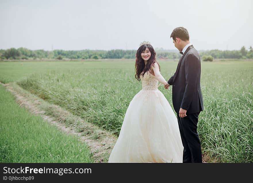 Groom and Bridge Along Hallway at Daytime