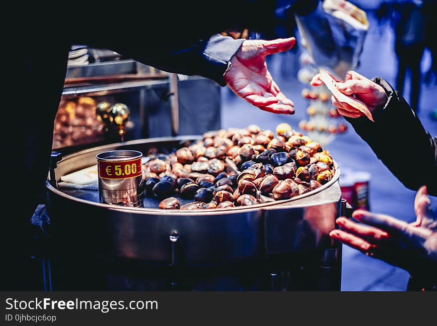 Person Paying Bill in Front of Nuts