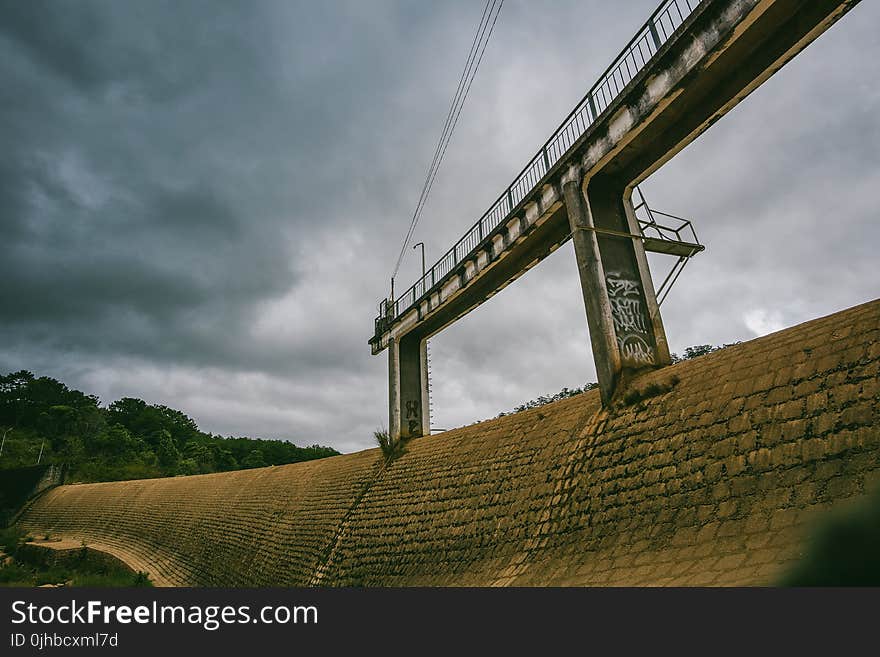 White Concrete Dam With Bridge