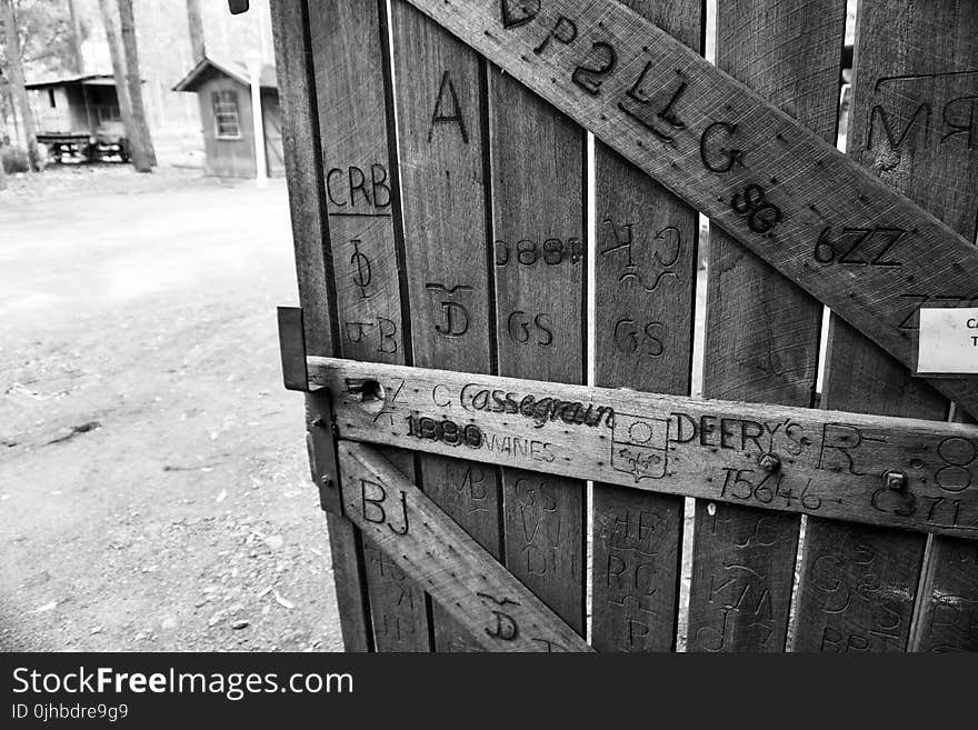 Gray Scale Photo of Brown Wooden Gate