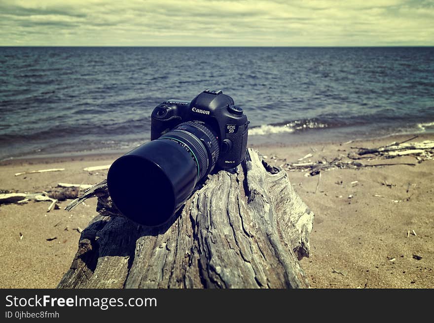 Black Canon Dslr Camera Near Sea Shore