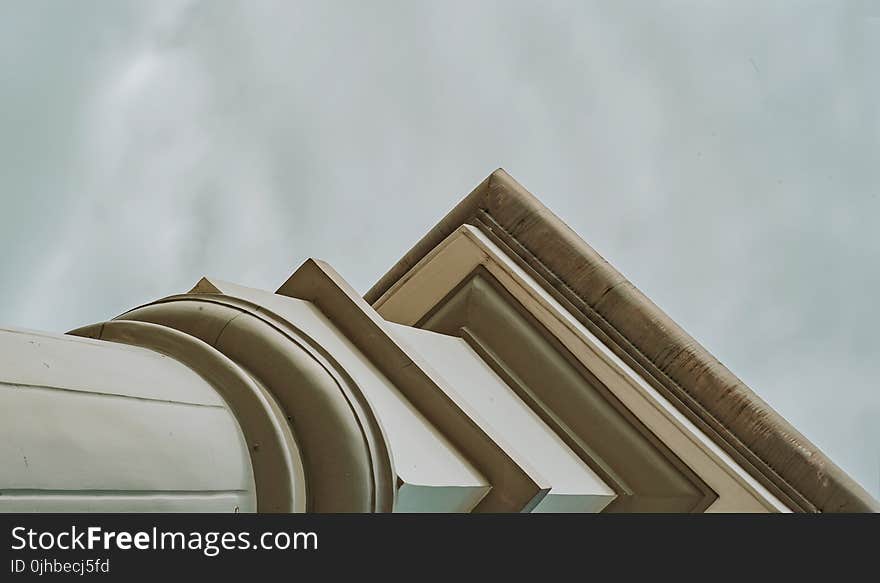 White Concrete Pedestal Column Facing the Rainy Sky