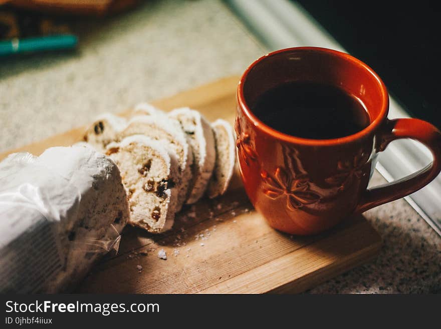 Brown Ceramic Mug Beside Cheese on Brown Wooden Serving Tray