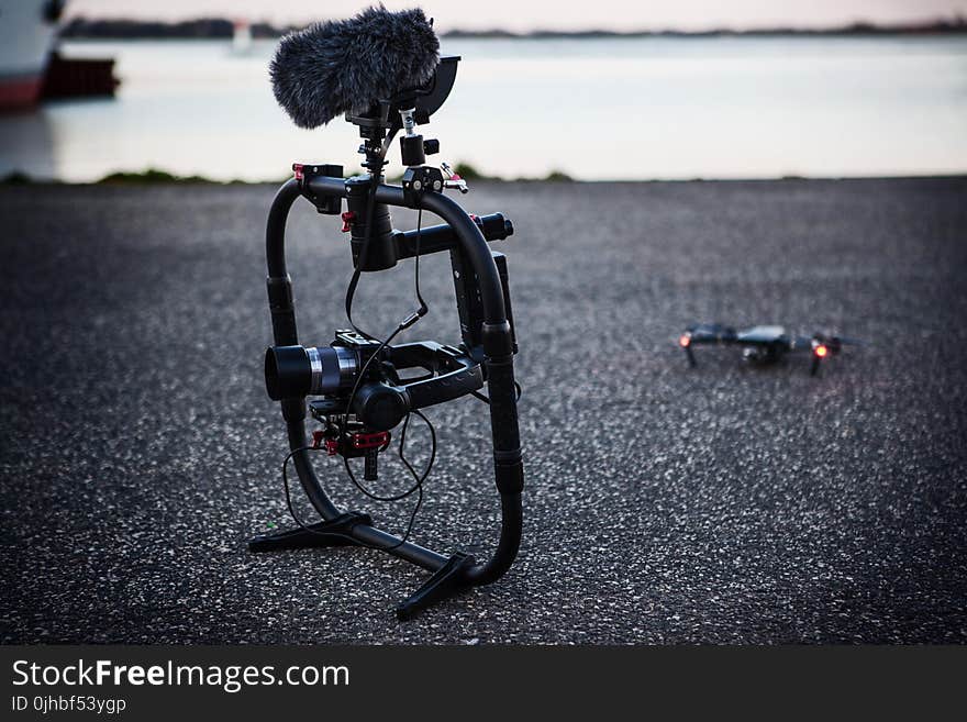 Shallow Focus Photography of Black Quadcopter Near Body of Water