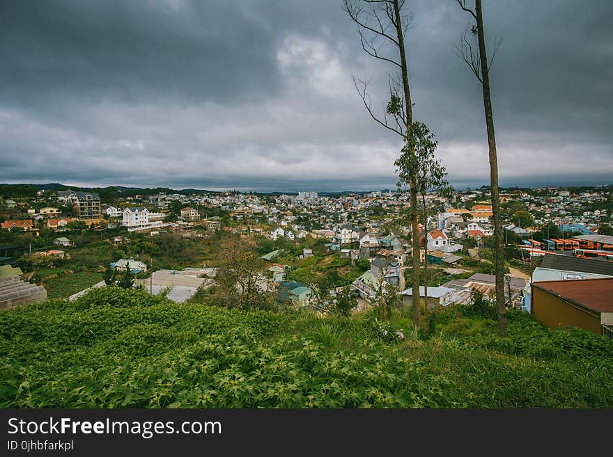 Scenic View of City Under Cloudy Sky