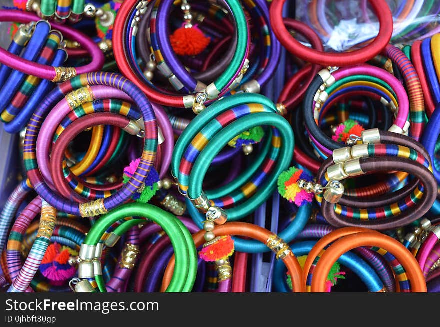 Pile Of Women&#x27;s Assorted Colored Bangles