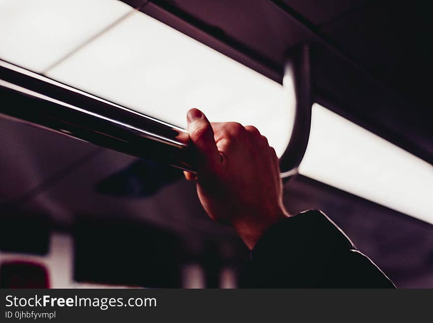 Human&#x27;s Hand Holding on Silver Handle Bar Photography