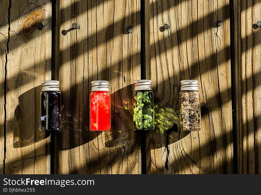 Several Assorted-color Glass Bottles on Table