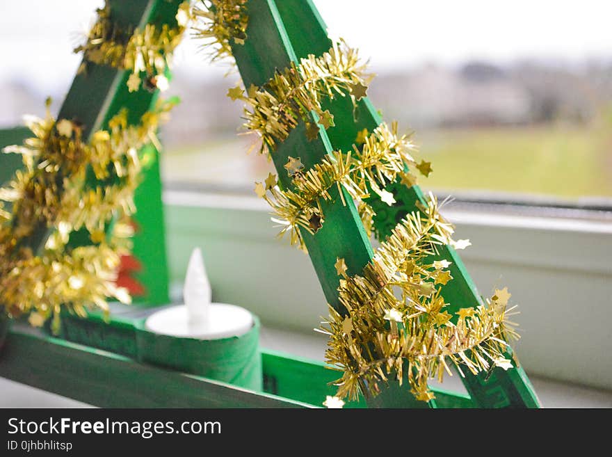 Shallow Focus Photography of Green and Yellow Candle Holder With White Candle