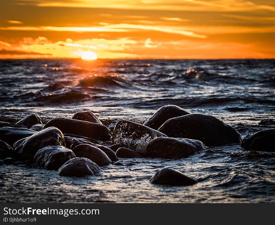 Stones on Beach during Sunset