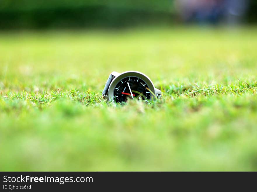 Round Grey And Black Analog Watch On Green Grass