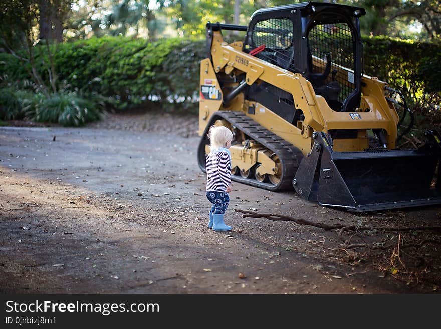 Toddler Stand Beside Front Loader