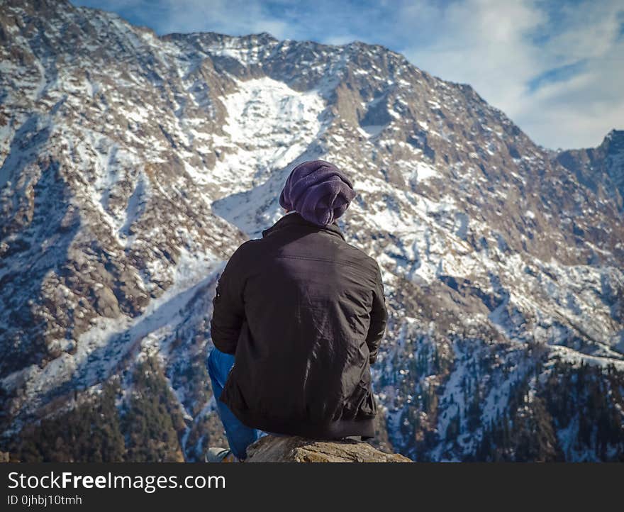 Person Sitting on Hill