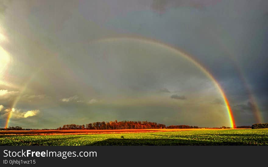 Photography of Green Grass Field With Rainbow