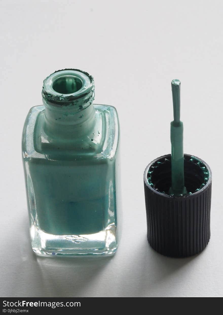 Shallow Focus Photography of Teal Nail Lacquer