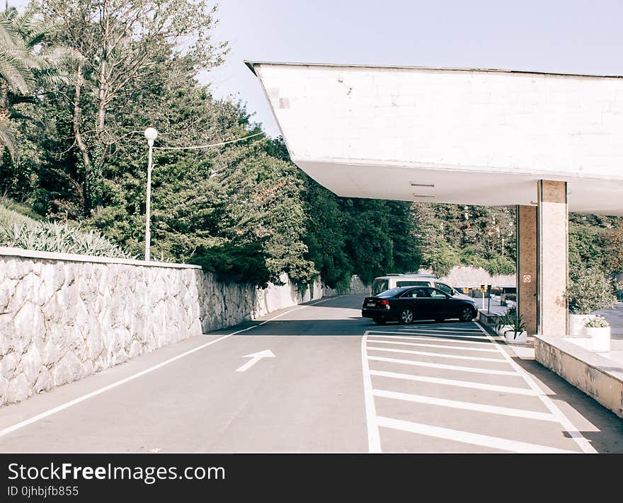 Black Car Parked on Gray Pavement