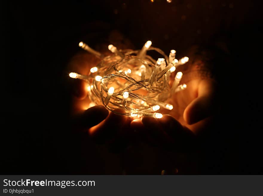 Person Showing White String Lights during Nightime