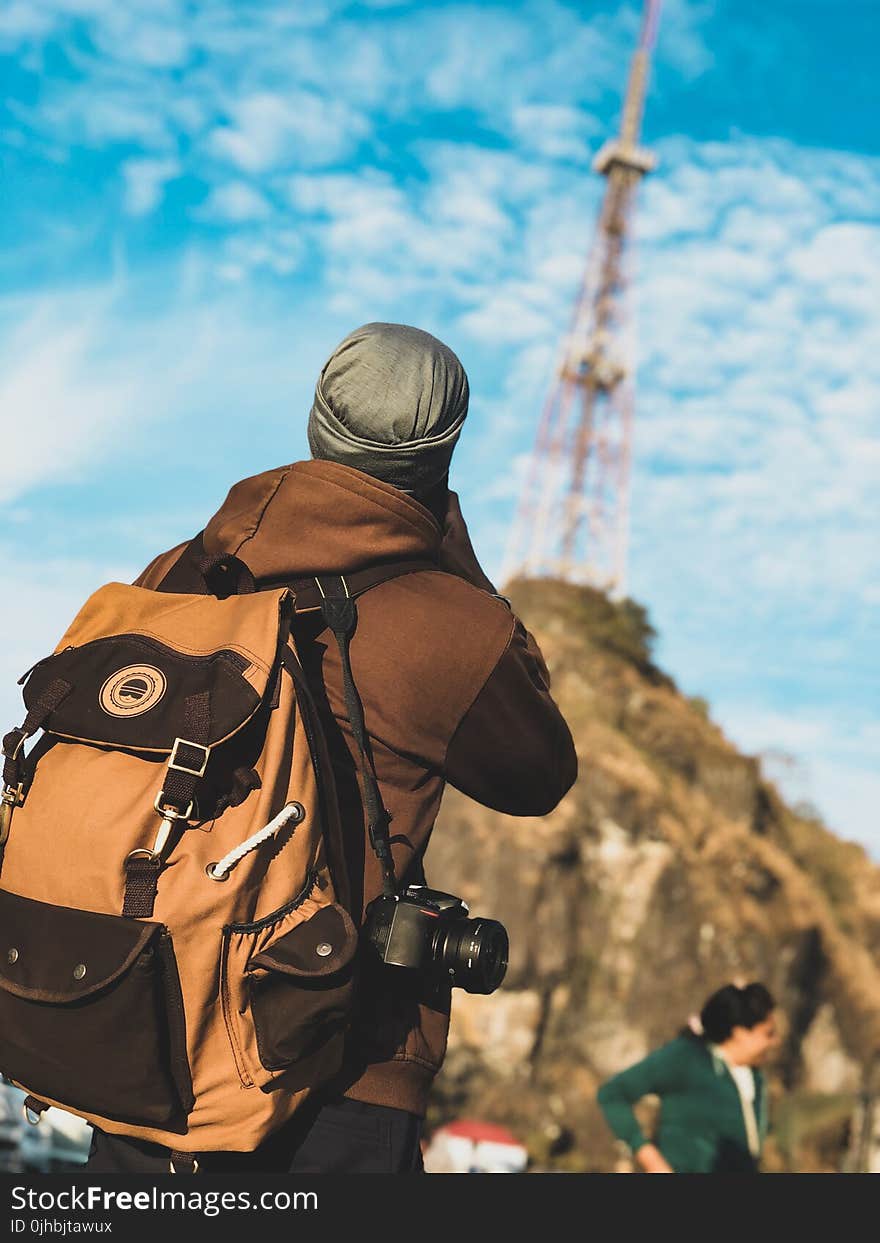 Focus Photography of Person Wearing Brown and Black Jacket With Brown and Black Backpack